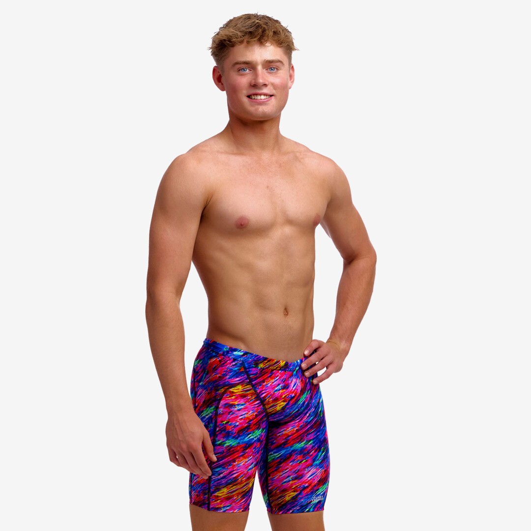Boy wearing funky trunks jammer in big bang pattern