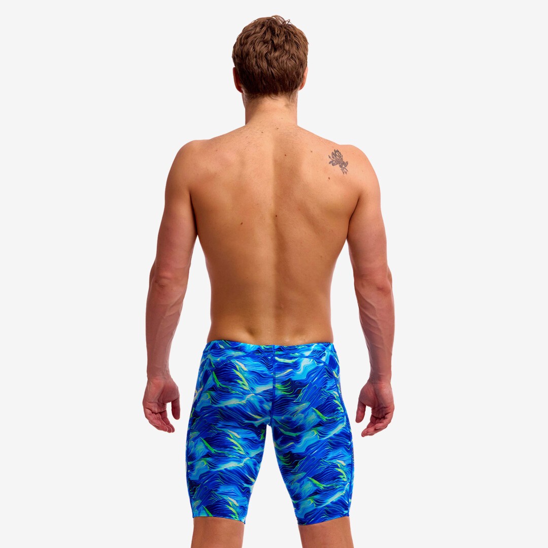 man wearing funky trunks jammer in storm chaser pattern, showing back