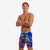 Man wearing colorful swim shorts with 'Funky Trunks' branding on a white background