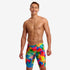 funky trunks jammers, mens tight swimming bottoms, rainbow painted pattern colour, man standing in swim shorts with white background