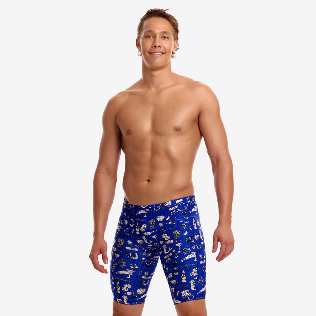 funky trunks jammers, mens tight swimming bottoms, blue with white details, man standing in swim shorts with white background