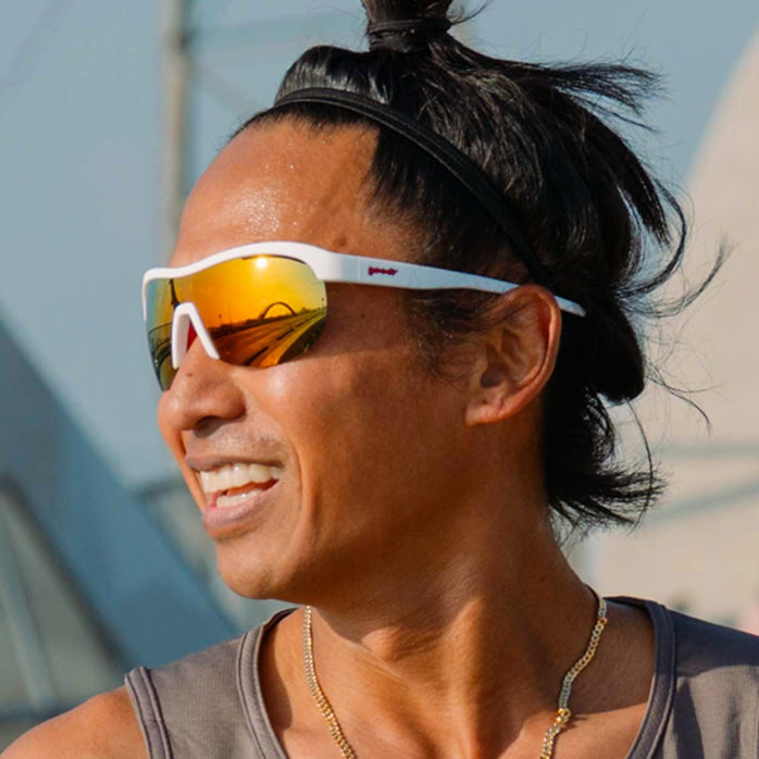 goodr sonic g wrap sunglasses for running with frame vents, white frame with mirrored reflective lenses, person wearing sunglasses while running