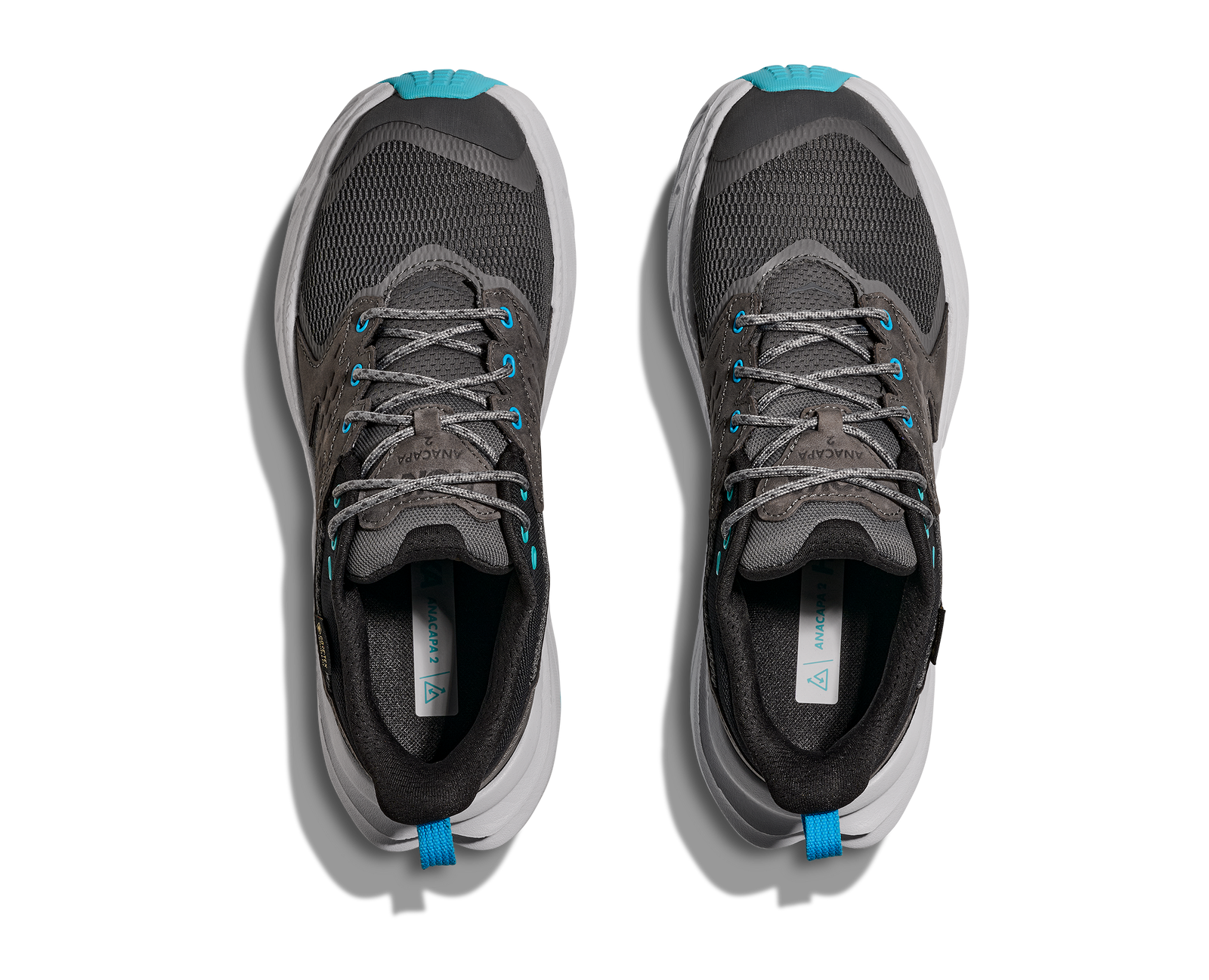 Pair of dark grey hoka waterproof womens hiking shoe with light grey and blue accents looking down