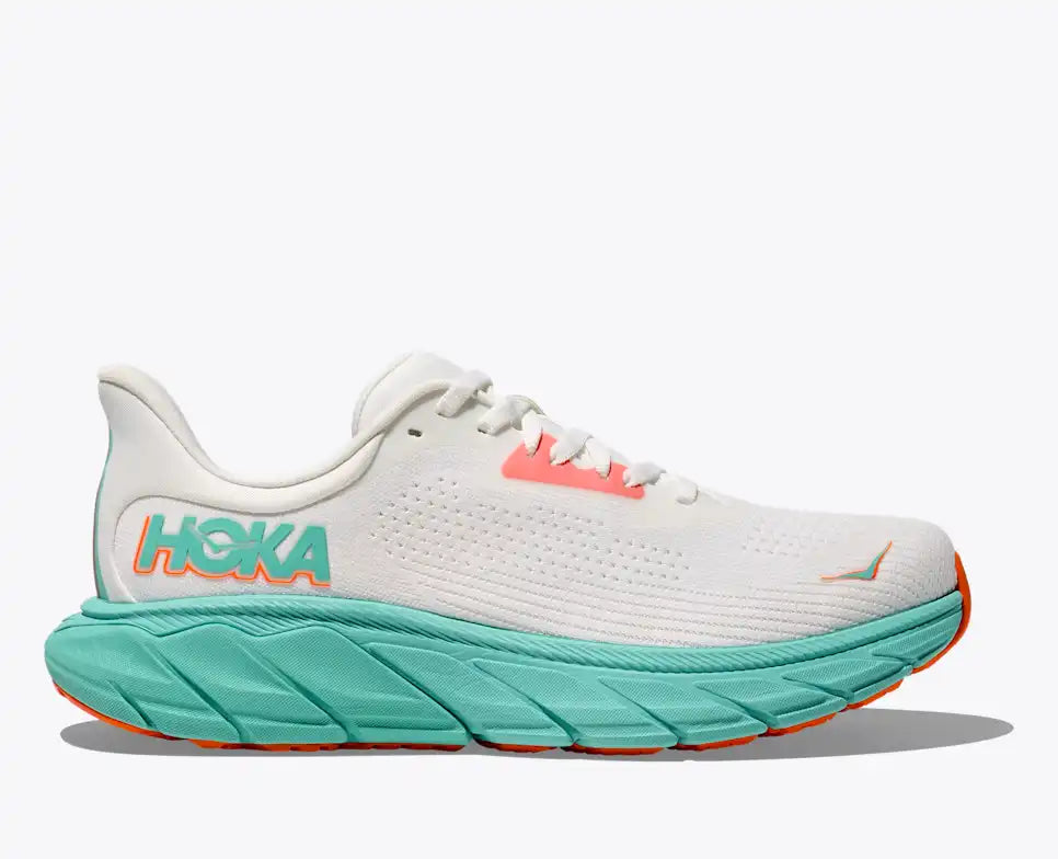 hoka arahi 7 for women, supportive lightweight running shoe, white with teal sole and orange accents, side profile of shoe