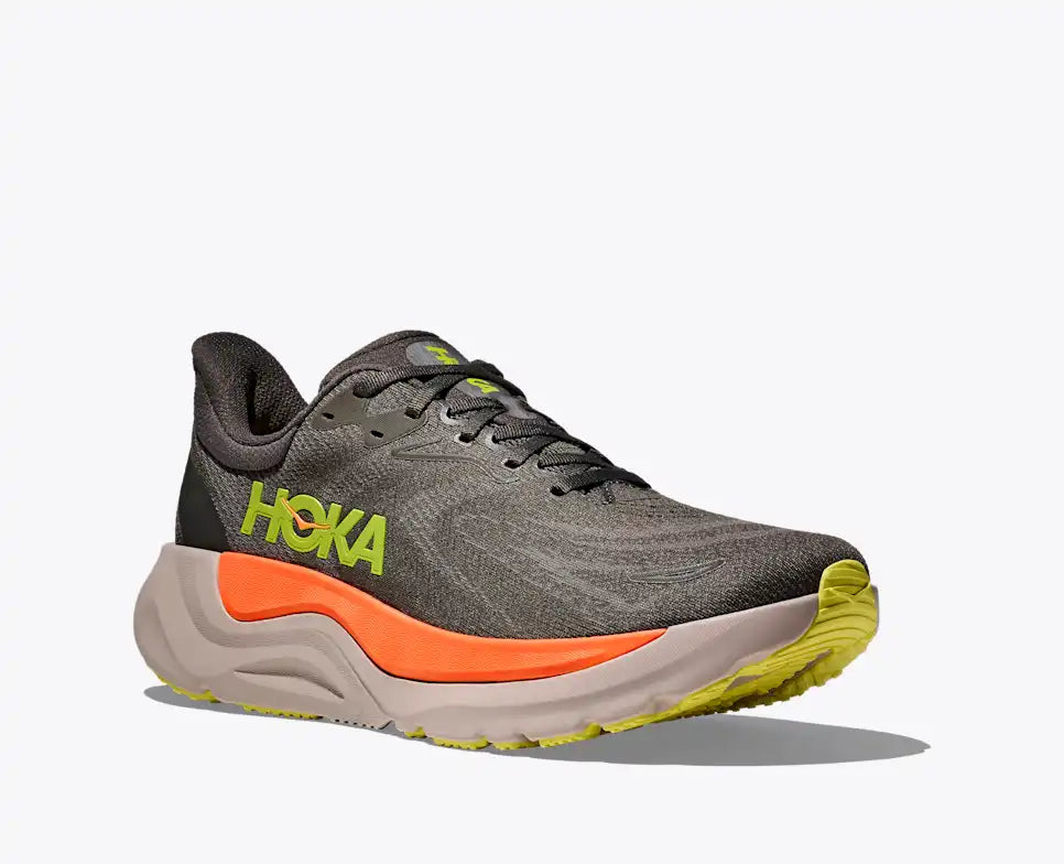 hoka arahi 8 for men, lightweight cushioned running shoe with support to correct overprontaion, dark grey colour with lime green details and orange on sole, angled side profile of shoe