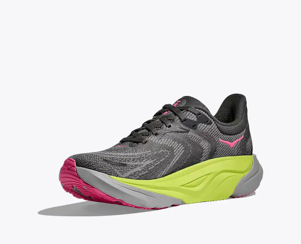 hoka arahi 8 for women, lightweight cushioned support shoe for overpronation when running, dark grey colour with pink details and lime green and grey sole, inside angled profile of shoe