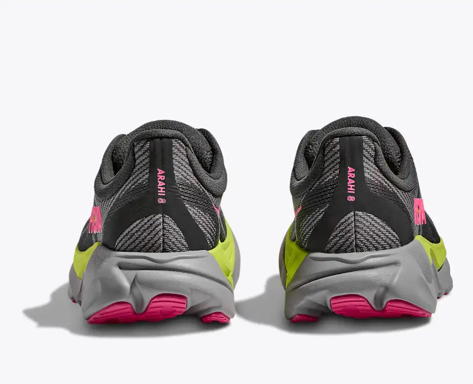 hoka arahi 8 for women, lightweight cushioned support shoe for overpronation when running, dark grey colour with pink details and lime green and grey sole, close up on heels of shoe