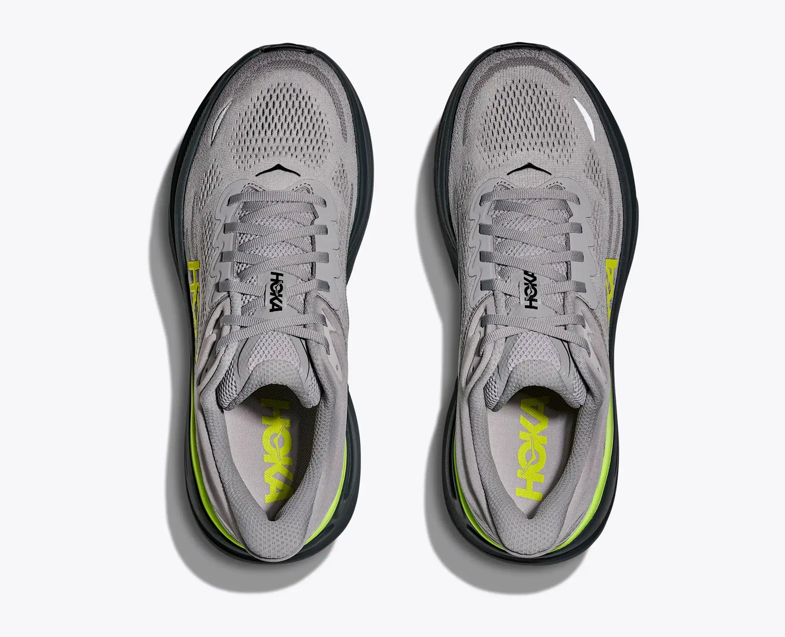 Light grey hoka bondi 9 running shoe with black and green accents