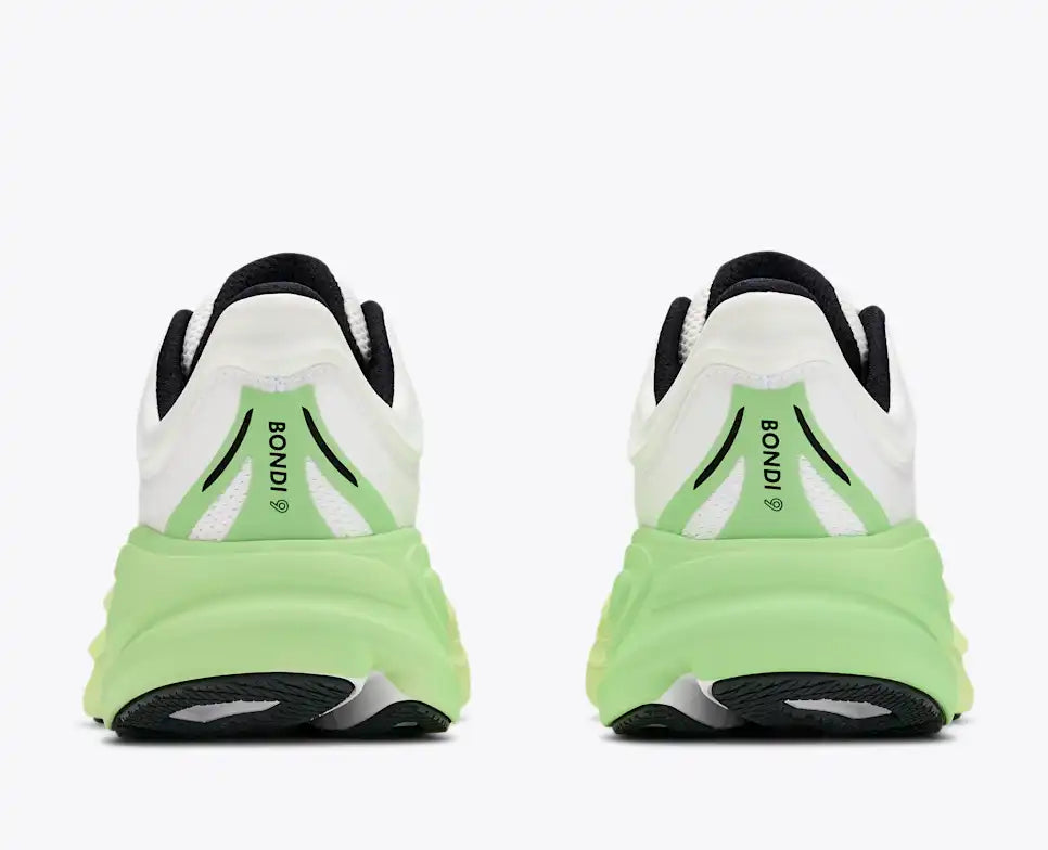 hoka bondi 9 womens, super cushioned road running and walking shoe, white colour with green and yellow sole, picture of shoe on white background.