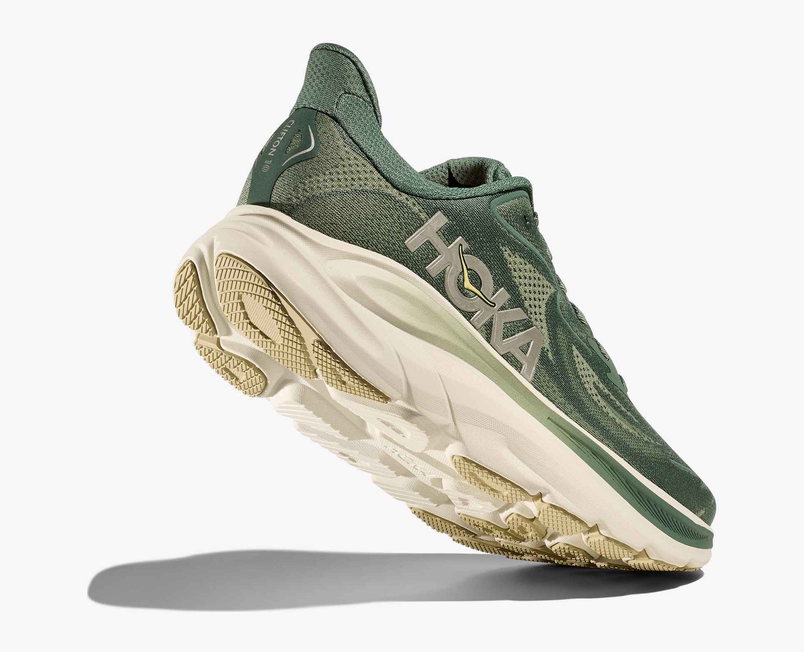 dark green hoka mens running shoe with beige heel