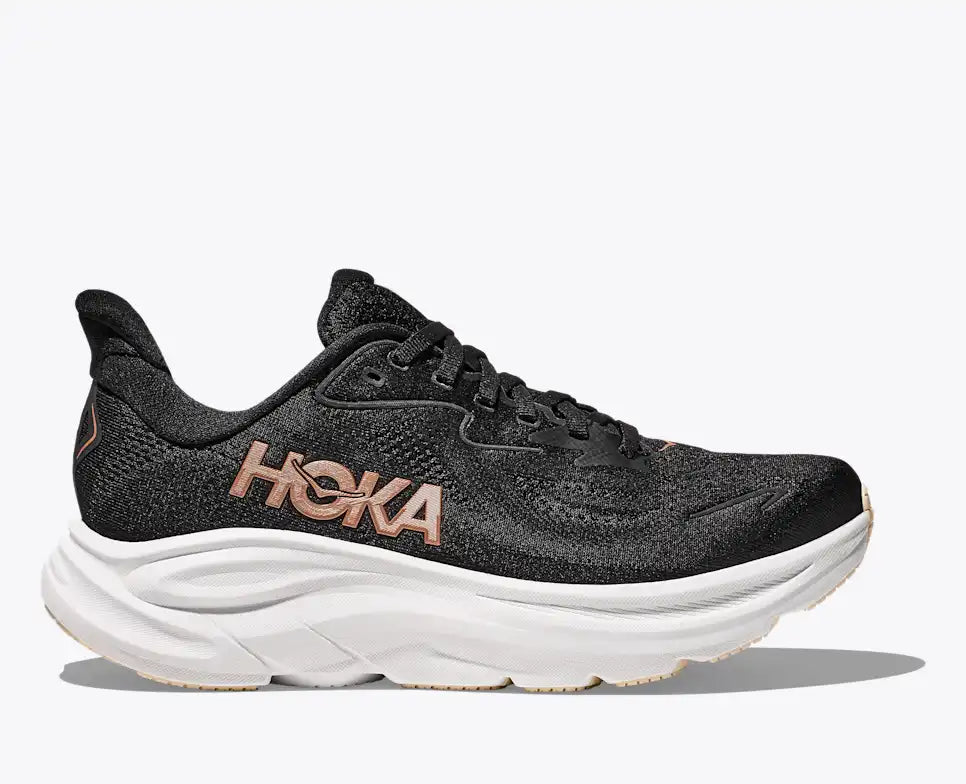 hoka clifton 10 running shoe for women, light and comfortable shoe for everyday running, black with rose gold details, profile of shoe on a white background