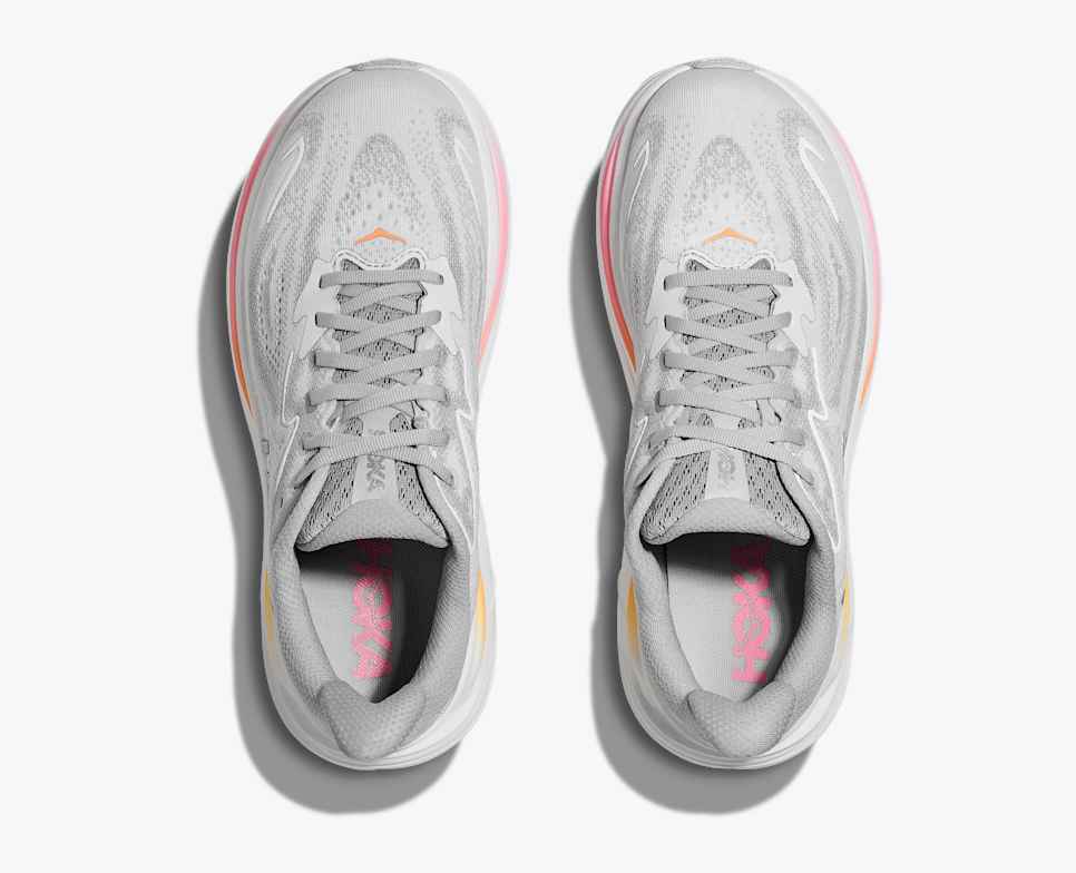 hoka clifton 10 womens, lightweight everyday running shoe, light grey colour with pink and orange details on white sole,  top down view