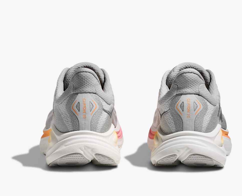 hoka clifton 10 womens, lightweight everyday running shoe, light grey colour with pink and orange details on white sole, side profile heel close up