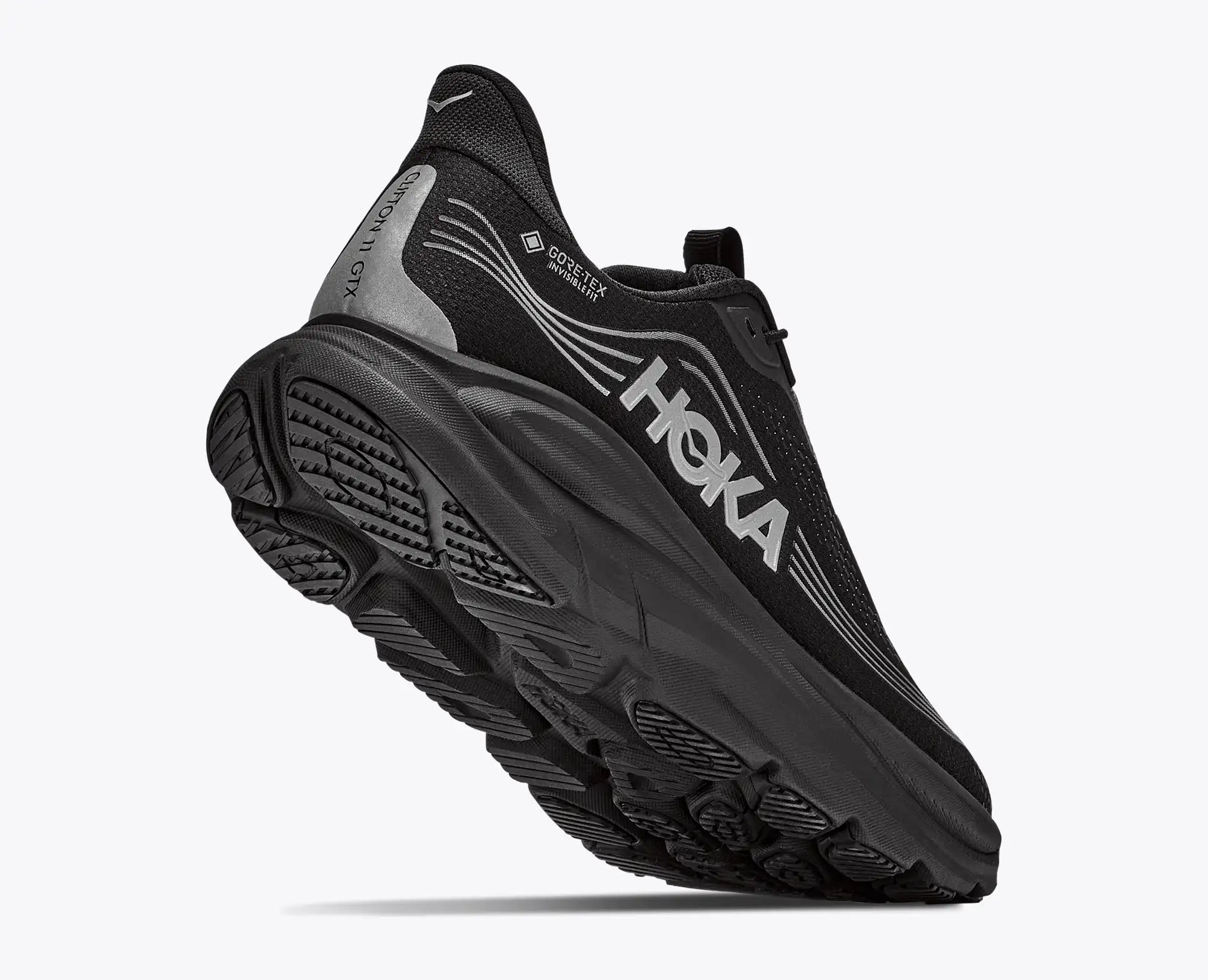 hoka clifton 11 GTX mens, lightweight cushioned waterproof road running and walking shoe with quick elastic tie, black with black sole and reflective silver details, back of shoe with heel lifted