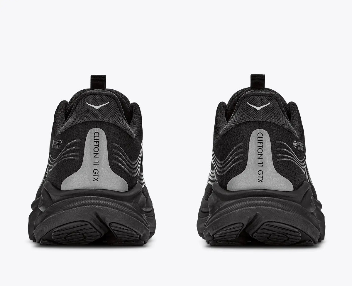 hoka clifton 11 GTX mens, lightweight cushioned waterproof road running and walking shoe with quick elastic tie, black with black sole and reflective silver details, heels of shoe