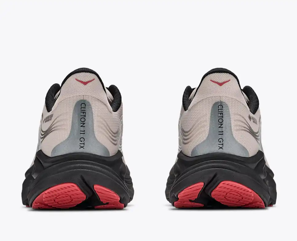 Hoka Clifton 11 GORE-TEX mens in a grey upper with a black sole and red details on the laces and sole. The Clifton 11 GORE-TEX® is engineered to seal out the elements with a GORE-TEX® Invisible Fit membrane, closed mesh upper, and water-repellant coating. rear view of both shoes. 