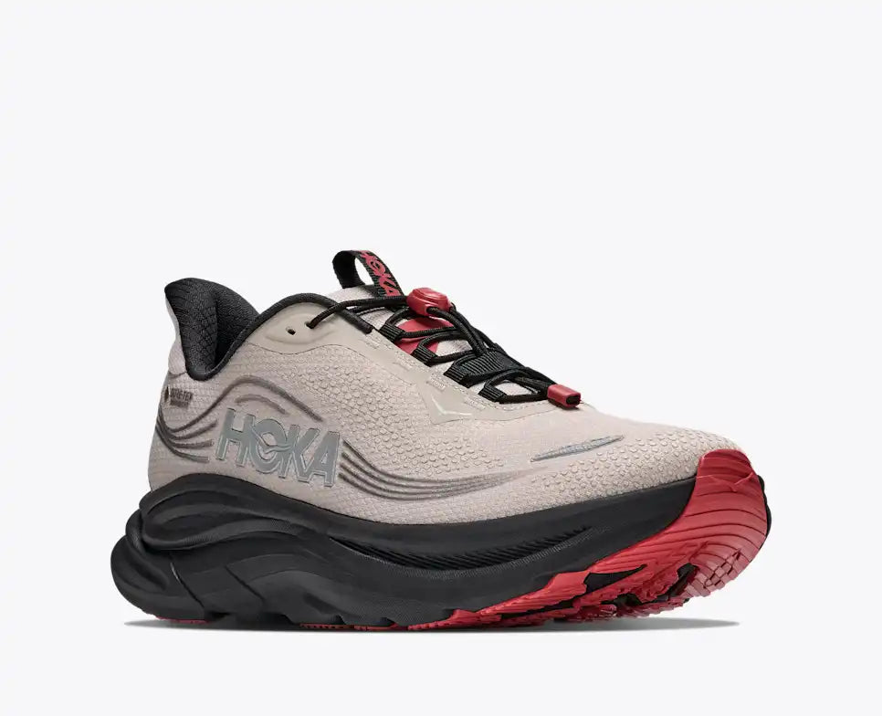 Hoka Clifton 11 GORE-TEX mens in a grey upper with a black sole and red details on the laces and sole. The Clifton 11 GORE-TEX® is engineered to seal out the elements with a GORE-TEX® Invisible Fit membrane, closed mesh upper, and water-repellant coating. Front side view of shoe