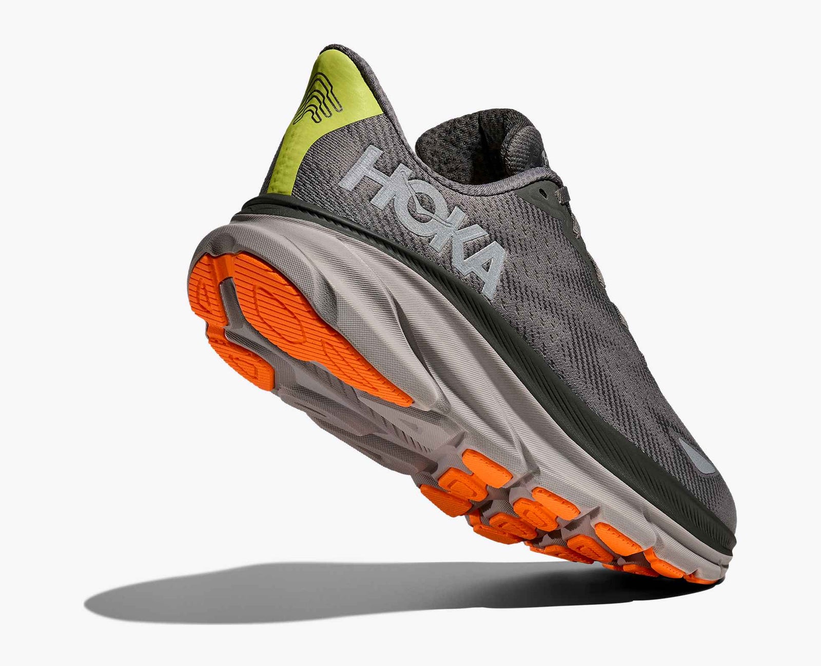 Dark grey hoka mens waterproof running shoe with orange and grey sole with heel lifted