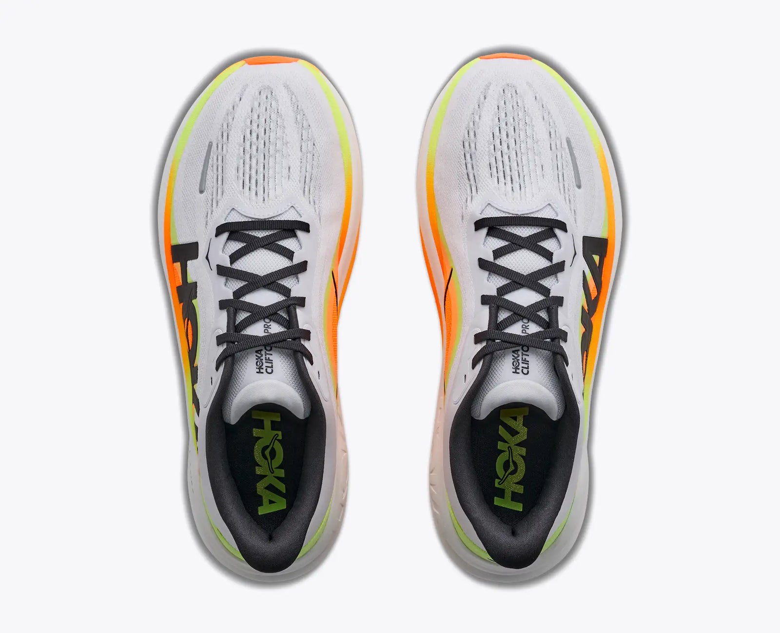 hoka clifton pro mens, responsive soft cushioned daily running shoe for faster paces, white shoe with neon orange and yellow details and black hoka logo, top view of shoe