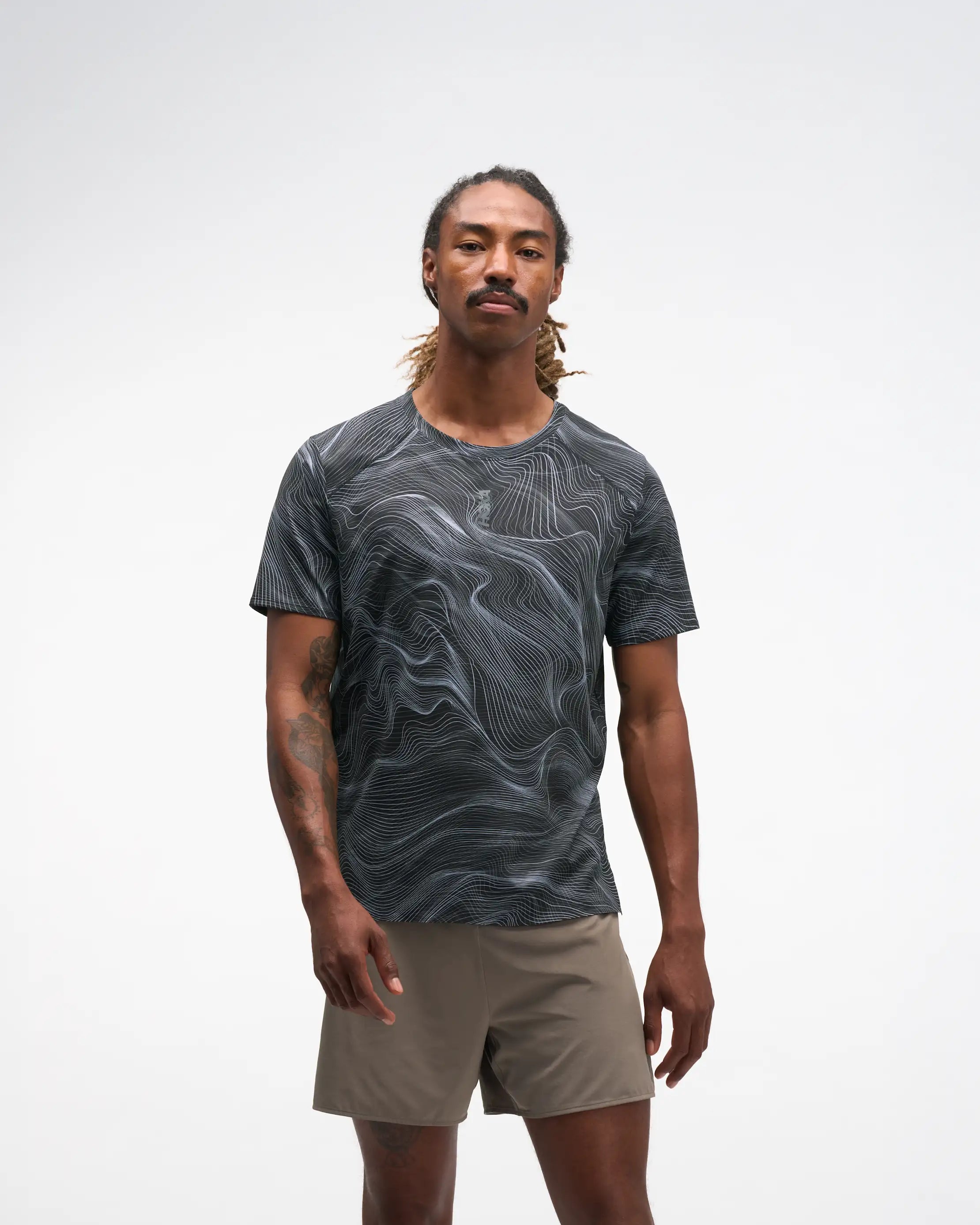 hoka everyrun men short sleeve shirt, lightweight and breathable running shirt with white wave line design on black tshirt, man wearing shirt 