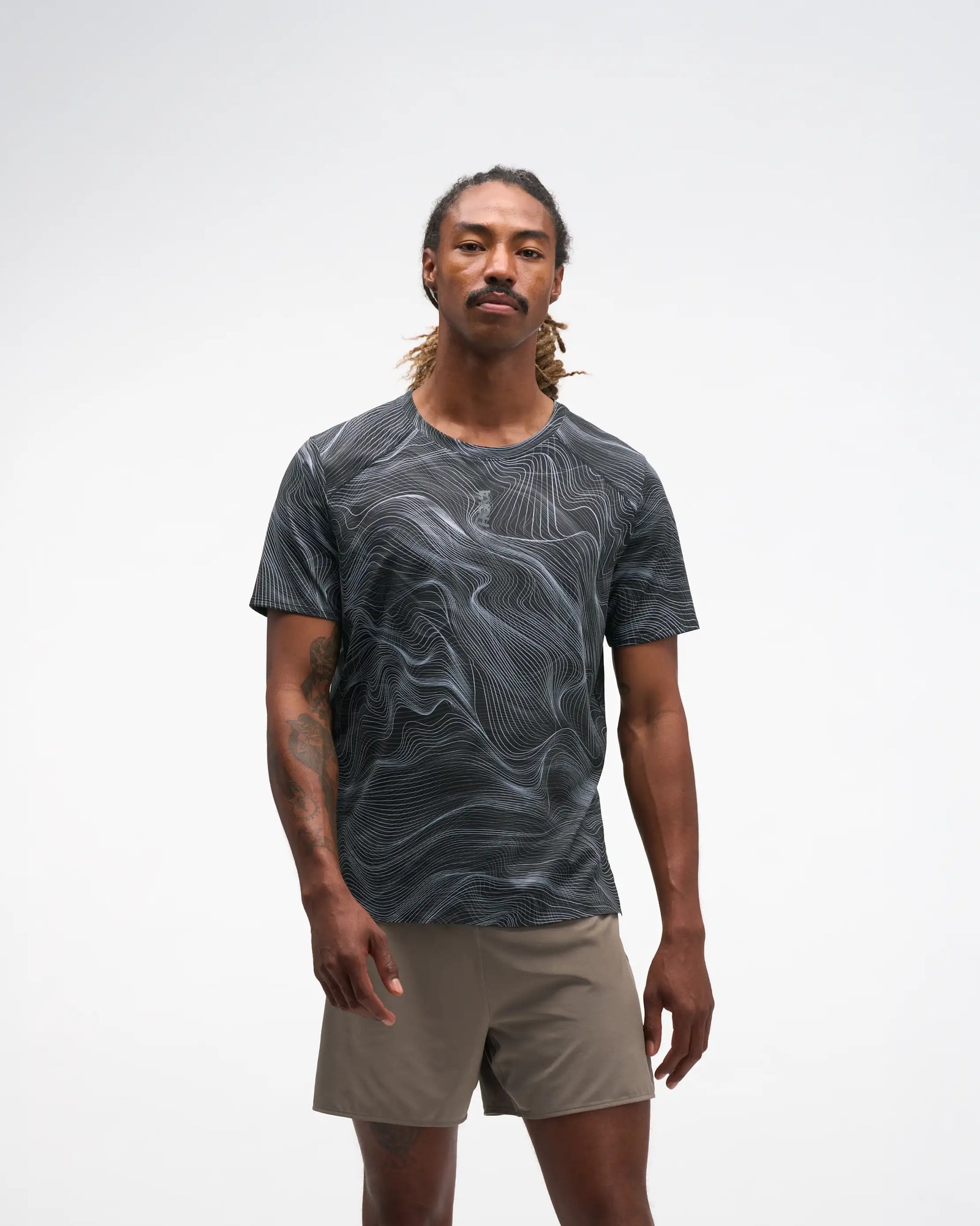 hoka everyrun men short sleeve shirt, lightweight and breathable running shirt with white wave line design on black tshirt, man wearing shirt 