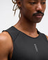 hoka everyrun tank top for men, light breathable running singlet , black colour with silver reflective HOKA logo, close up of a man wearing hoka tank