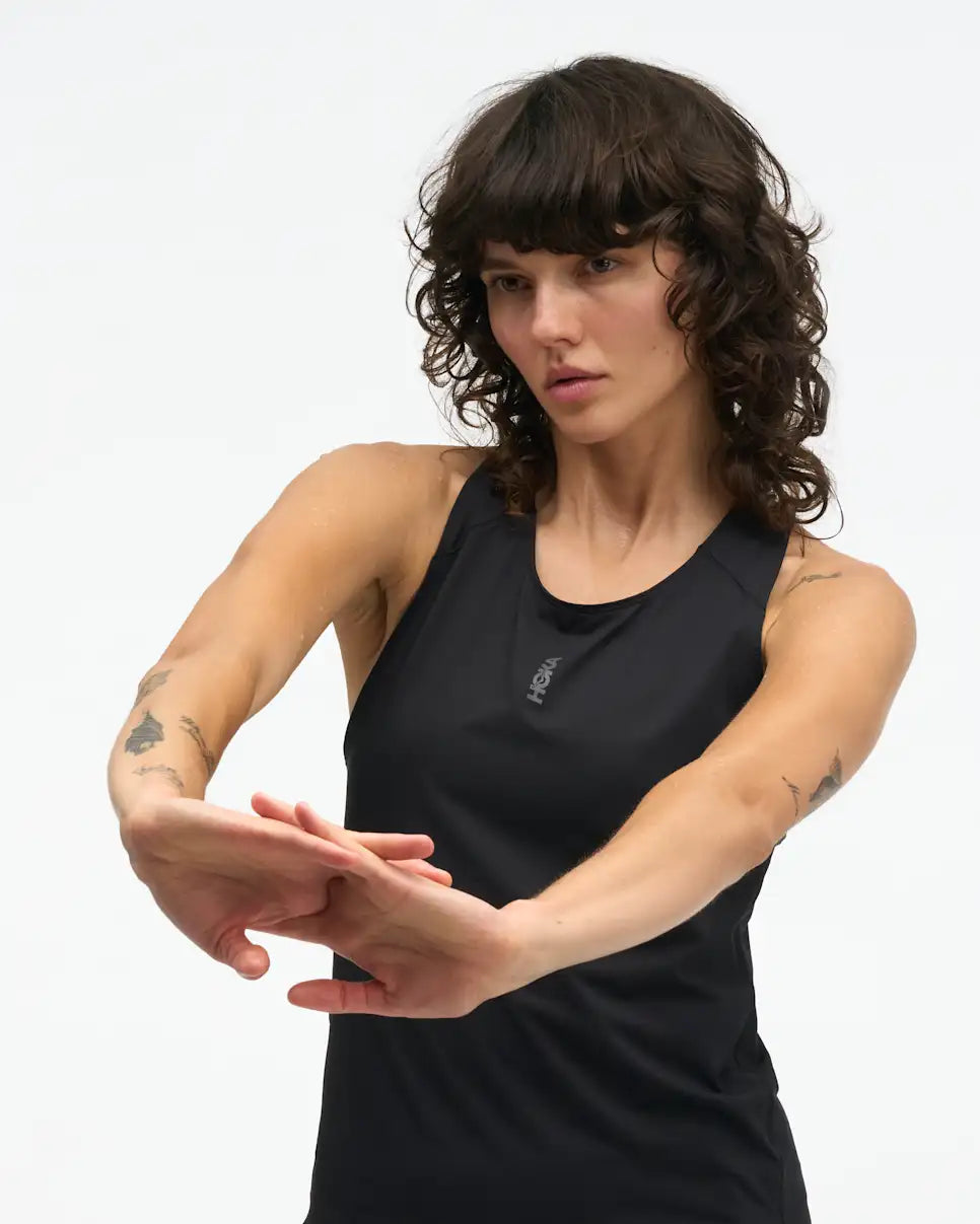 hoka everyrun womens tank in black. The  ultralight tank is tuned for daily training with comfort-first design details. Cut from our breathable, quick-dry FlyLite™ material, the slim-fit silhouette wicks sweat to keep you dry from first mile to last.