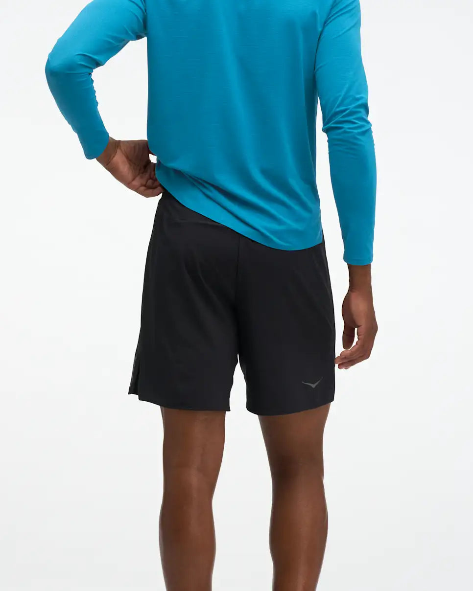 HOKA Glide 7'' Short 2-in-1, lightweight running short with inner short, black colour, back of man wearing shorts with long sleeve blue top
