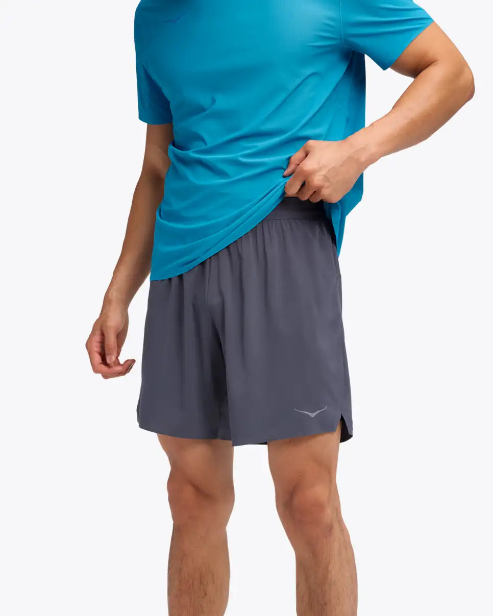 man wearing hoka glide 7 inch run shorts, 2 in 1 run shorts