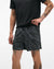 hoka 5" glide short with internal brief, black colour with white swirl pattern, man wearing hoka shorts with a black t-shirt on a white background