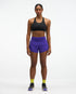 Hoka glide short mr 3.5", sweat wicking trail and road running shorts with pockets, purple shorts, woman wearing black sports bra with purple shorts with neon green socks and black runners