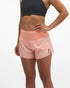 Hoka glide short mr 3.5", sweat wicking trail and road running shorts with pockets, light peach coloured shorts, woman wearing black sports bra with light peach shorts