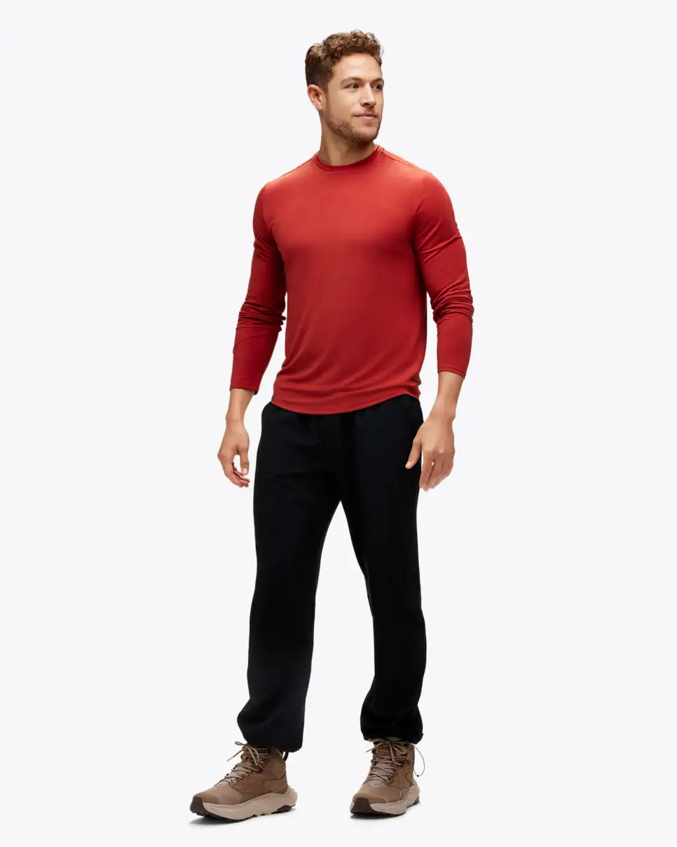 Man wearing hoka long sleeve run top in rusty red colour