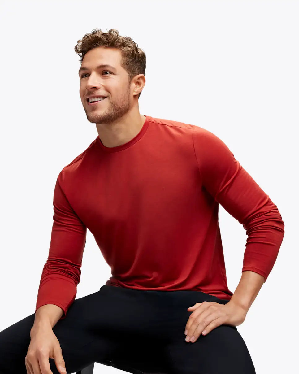 Man wearing hoka long sleeve run top in rusty red colour
