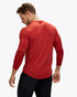 Man wearing hoka long sleeve running top in red colour, showing back with logo