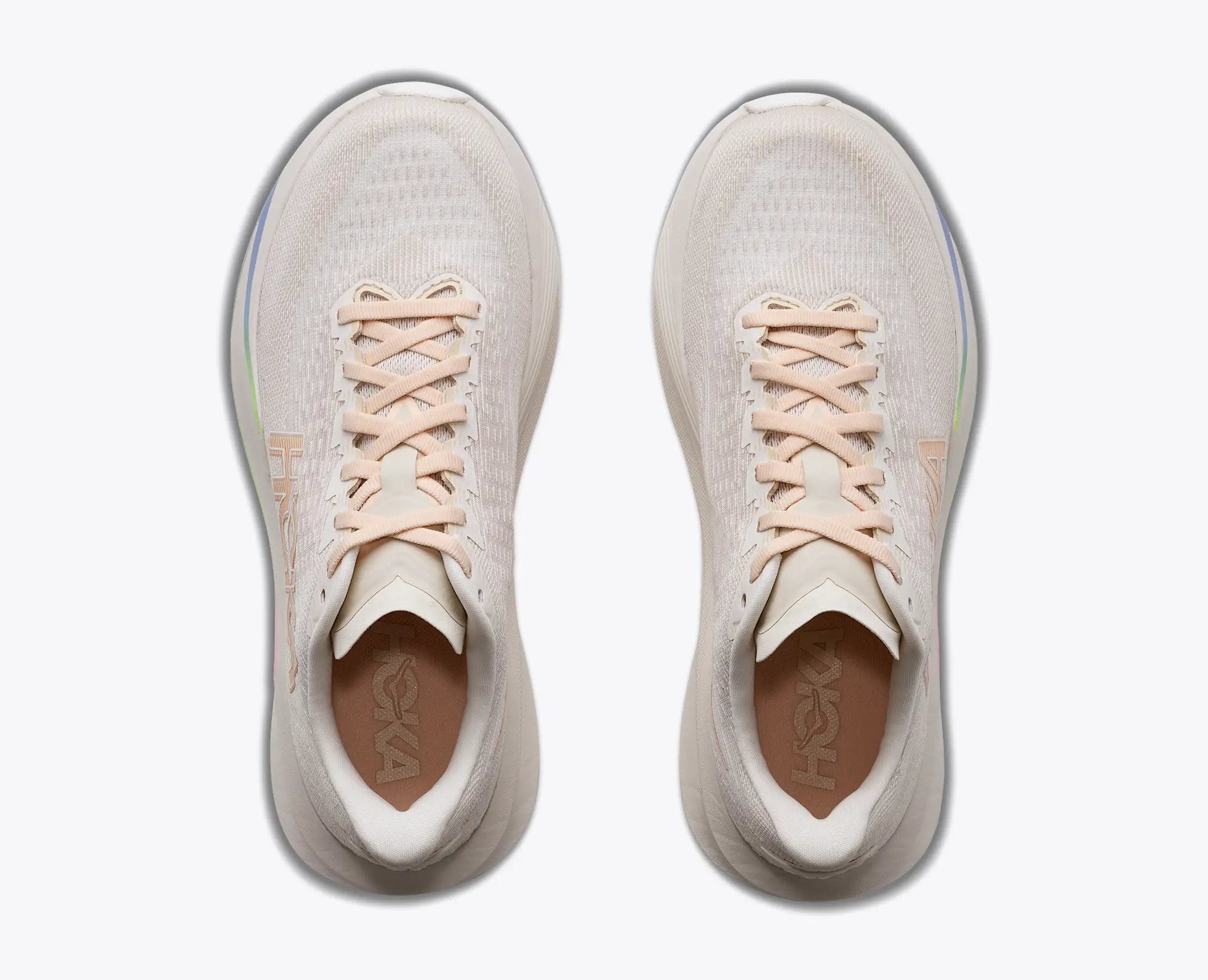 hoka mach 7, fast lightweight everyday running shoe with cushioning, light beige and white with peach laces and logo and rainbow detail, top view of shoes