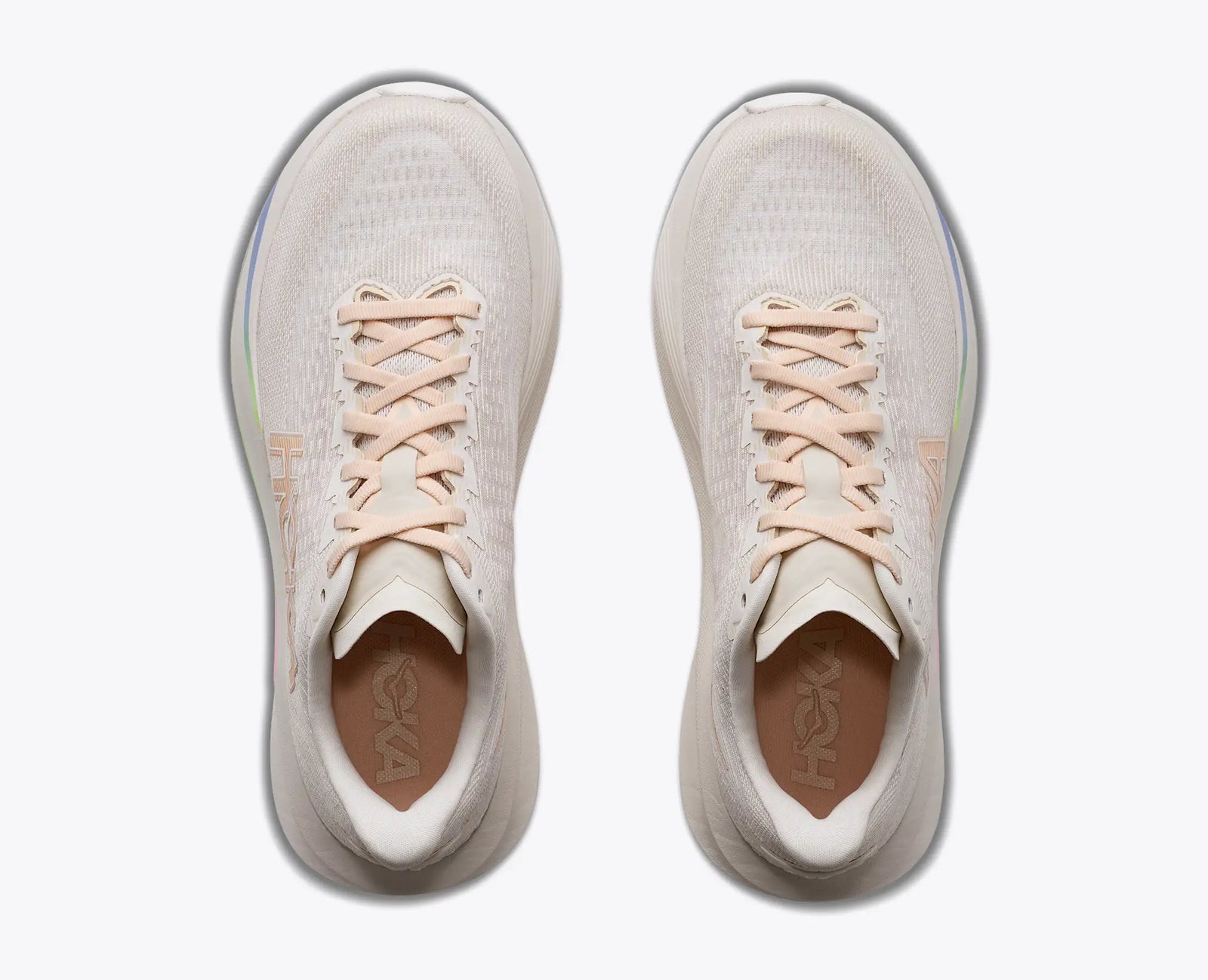 hoka mach 7, fast lightweight everyday running shoe with cushioning, light beige and white with peach laces and logo and rainbow detail, top view of shoes
