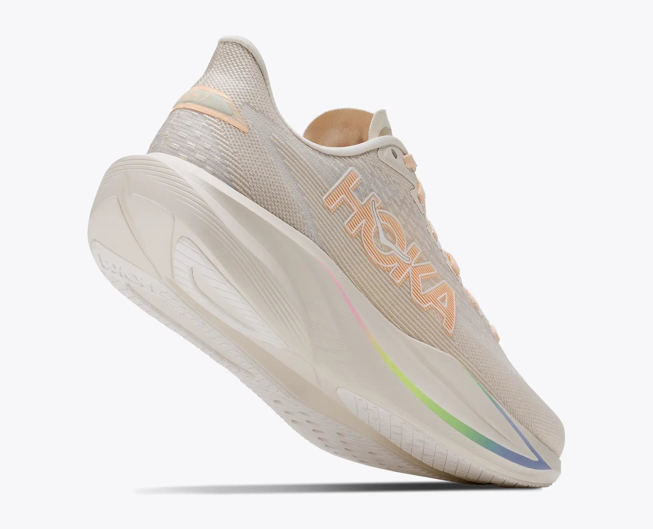 hoka mach 7, fast lightweight everyday running shoe with cushioning, light beige and white with peach laces and logo and rainbow detail, heel of shoe lifted showing sole