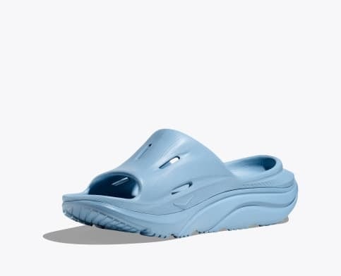 hoka ora recovery slide for all gender, comfortable and supportive slider for after run recovery, light blue colour, side profile of ora slide on a white background