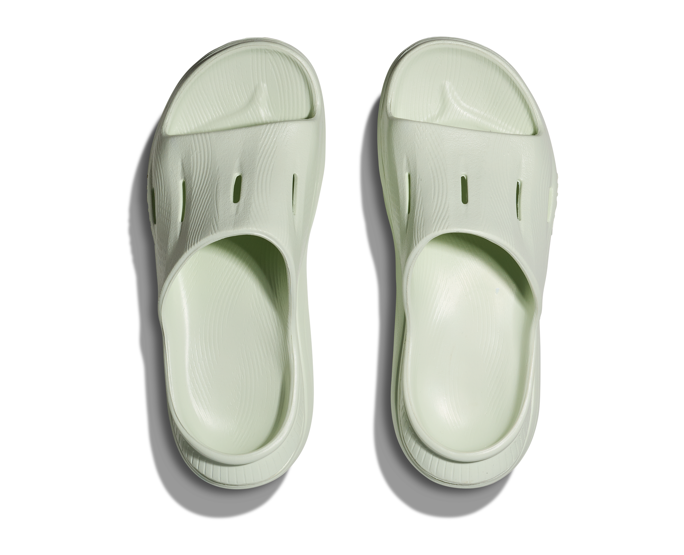 hoka ora recovery slide for all gender, comfortable and supportive slider for after run recovery, light green colour, overhead profile of ora slide on a white background