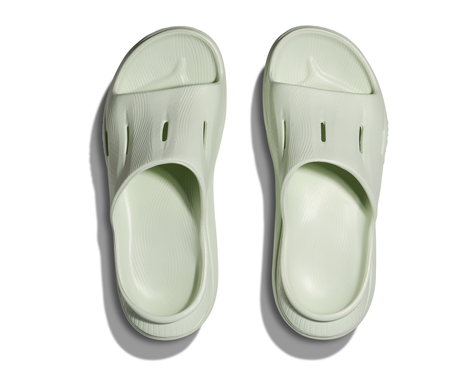 hoka ora recovery slide for all gender, comfortable and supportive slider for after run recovery, light green colour, overhead profile of ora slide on a white background