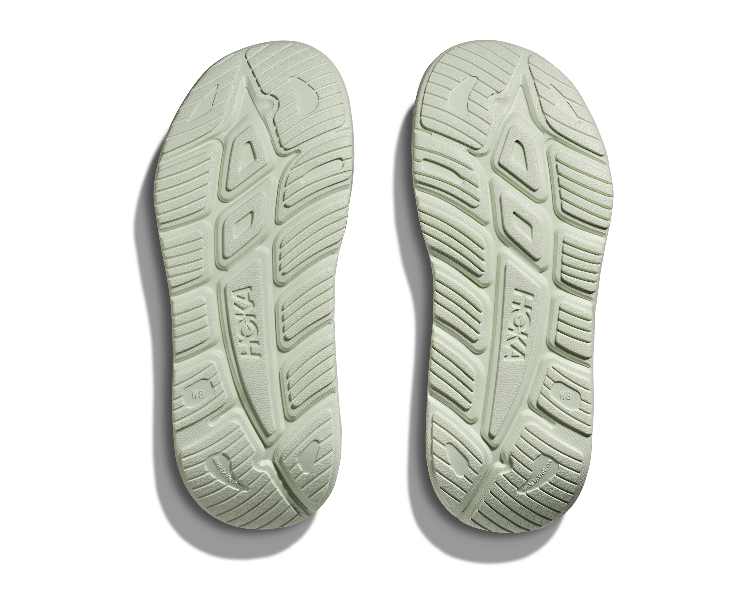 hoka ora recovery slide for all gender, comfortable and supportive slider for after run recovery, light green colour, bottom profile of sole of ora slide on a white background