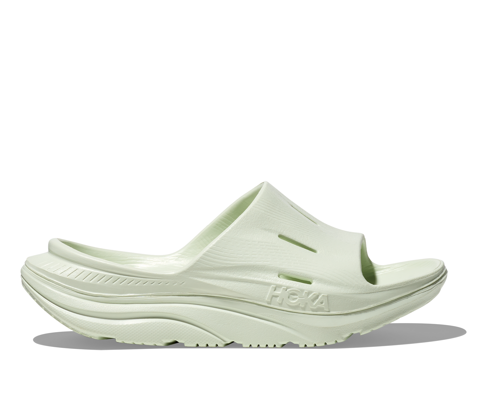 hoka ora recovery slide for all gender, comfortable and supportive slider for after run recovery, light green colour, profile of ora slide on a white background