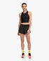 hoka race day bra, black crop top for warm weather running, full image of woman wearing hoka day bra and black shorts with pink shoes and yellow socks