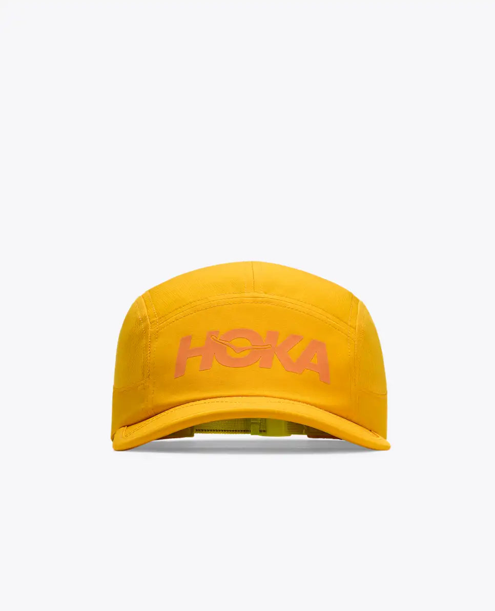 hoka running cap for all gender, lightweight breathable running cap, bright yellow colour with orange hoka logo, cap shown on a white background