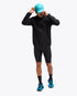 man wearing hoka skybreeze waterproof jacket, light waterproof gtx jacket for running, black colour with reflective details, full body view