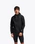 man wearing hoka skybreeze waterproof jacket, light waterproof gtx jacket for running, black colour with reflective details