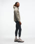 hoka men's skyglow half zip running top,  water resistant, stretchy long-sleeve pull over with a hood, light grey colour, side view of model wearing half-zip with black trousers on a white background