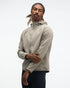 hoka men's skyglow half zip running top,  water resistant, stretchy long-sleeve pull over with a hood, light grey colour, front view of model wearing half-zip with black trousers on a white background