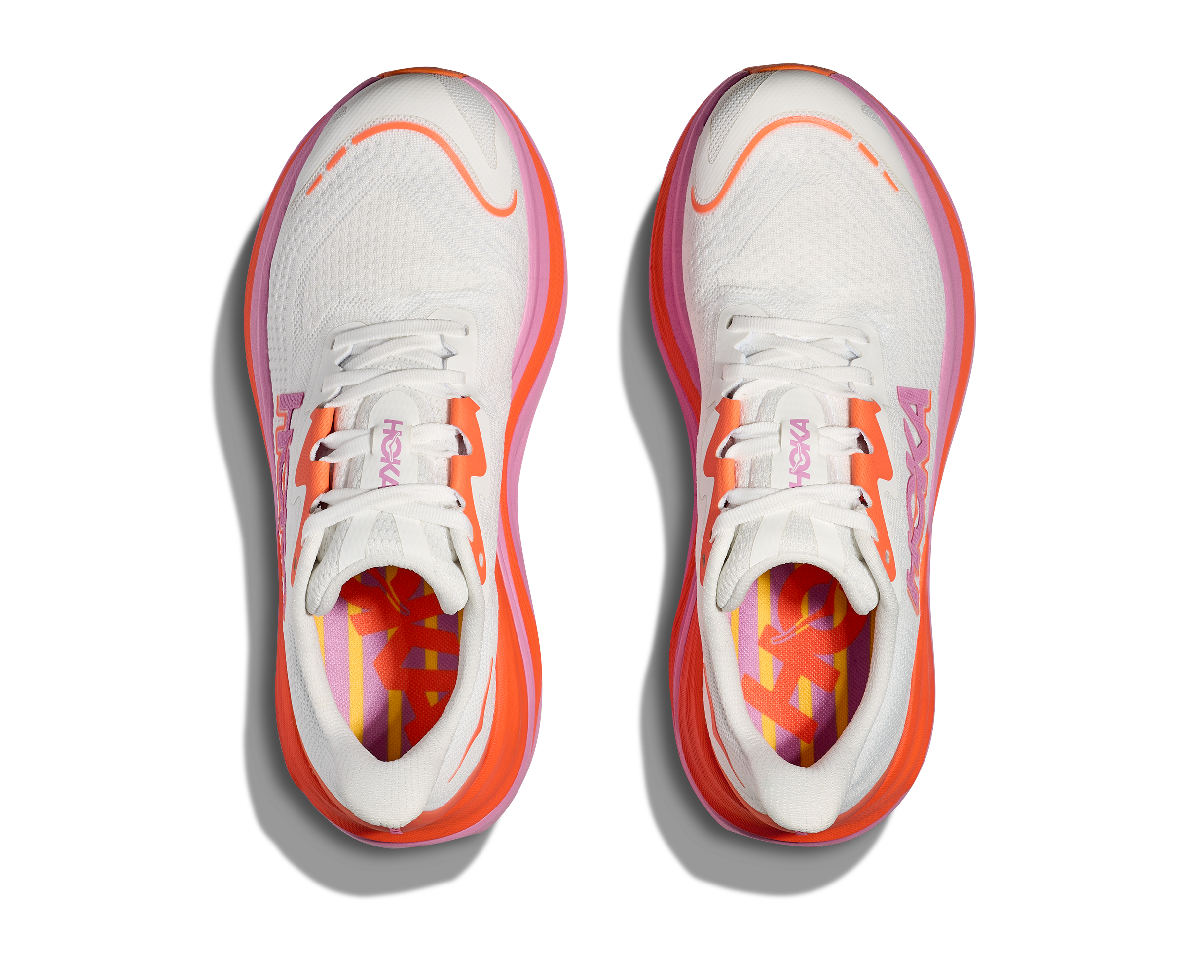Hoka skyward x for women, super cushioned carbon plated running shoe, white colour with orange and pink details, top dow view of shoes